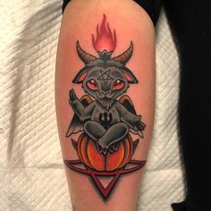 a person with a devil tattoo on their leg