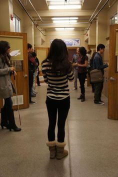 a group of people standing in a hallway