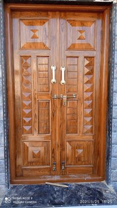 two wooden doors with decorative designs on the front and side panels, one is made out of wood