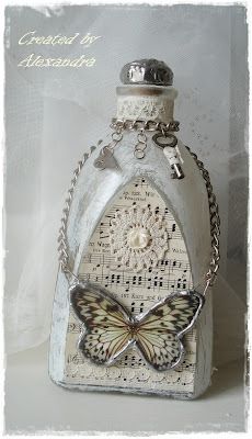 a white bottle with a butterfly on the top and chain around it's neck