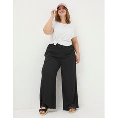 Easy styling awaits with our wide leg palazzo trousers. Whether youre headed off on a weekend adventure or mid-week errand, they pair beautifully with anything from tees to blouses. Cut for a flowy, wide leg fit thats cinched in at the waist by the presence of a shirred waist band, these trousers are as a versatile as they are stylish. Their 100% LENZING ECOVERO viscose means that theyre soft, breathable and more sustainable. Plus Size Wide Leg Pants Outfit, Wide Leg Black Pants Outfit, Band Tee Outfits, Slacks Outfit, Plus Size Wide Leg Pants, Plus Size Wide Leg, Black Pants Outfit, Trousers Plus Size, Wide Leg Pants Outfit