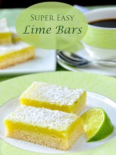 two slices of lime bars on a plate with a cup of coffee in the background