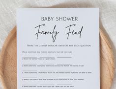 a baby shower card with the words family fund on it sitting on a wooden plate