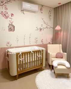 a baby's room with a crib and chair