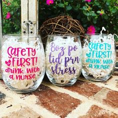 three wine glasses with words painted on them