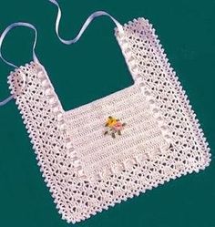 a white crocheted bag with flowers on it