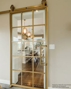 an open glass door leading to a dining room