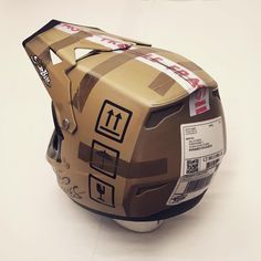 the helmet is made out of cardboard and has stickers on its side to indicate where it will be used