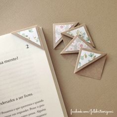 an open book with some origami pieces on it