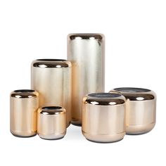 four metallic canisters are stacked on top of each other