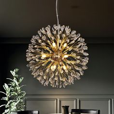 a chandelier hanging from the ceiling over a dining room table with two chairs