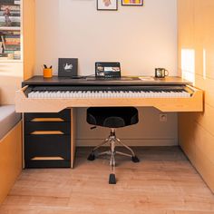 a computer desk with a keyboard on top of it in front of a wall mounted book shelf