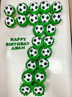 cupcakes are arranged in the shape of a number one with soccer balls on them