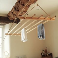 a kitchen with a wooden rack hanging from the ceiling