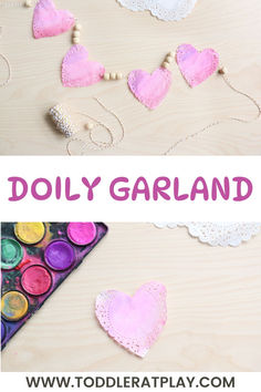 the words doly garland are made out of paper hearts and beads on a wooden table