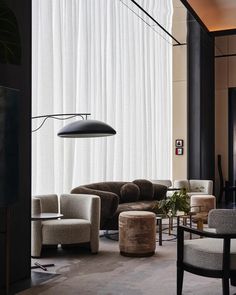 a living room filled with furniture next to a window