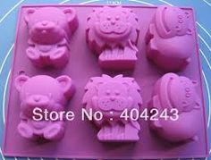 pink bear and pig shaped fondant moulders on a blue background