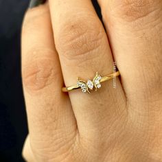 a woman's hand with a gold ring and three diamond rings on her fingers