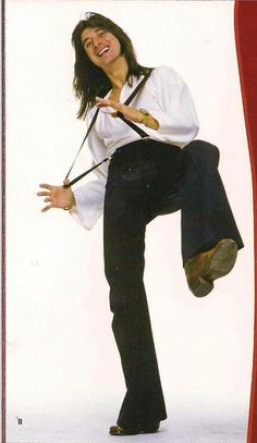 a woman in white shirt and black pants dancing