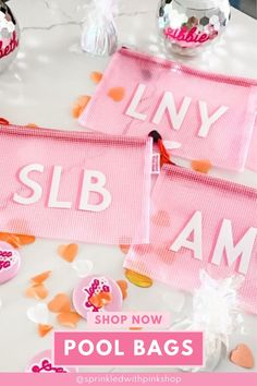 two pink towels with the words liny slb shop now on them and some confetti