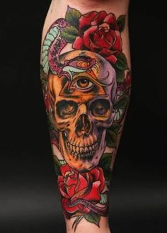 a skull and roses tattoo on the leg