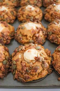 there are many cookies on the baking tray together, including one with white icing