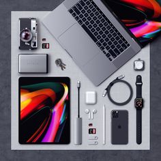 the contents of an apple macbook pro laptop and other electronics are laid out on a table