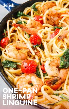 pasta with shrimp, tomatoes and spinach in a skillet