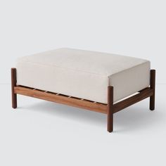 a wooden bench with a white cushion on it