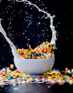 a white bowl filled with cereal and sprinkles on top of a table