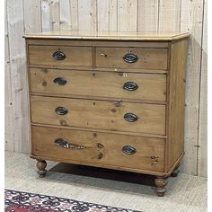 an old wooden chest of drawers with knobs