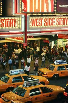 taxi cabs are parked in front of the west side story theater