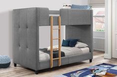 a gray bunk bed with blue pillows in a room