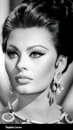 a woman with large earrings on her head and dark hair, in black and white