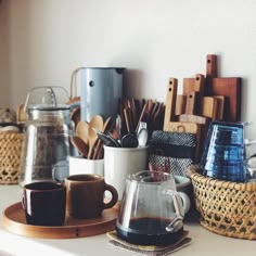 a table with coffee cups and tea kettles on it, in an instagram