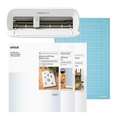 the cricut machine is sitting on top of paper and next to it's instruction manual