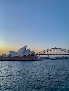 the sydney opera house and harbour bridge at sunset