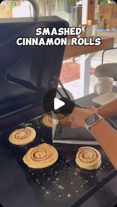 someone is making cinnamon rolls on the grill