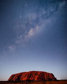 the night sky over ulururua and aye rock in australia's outback