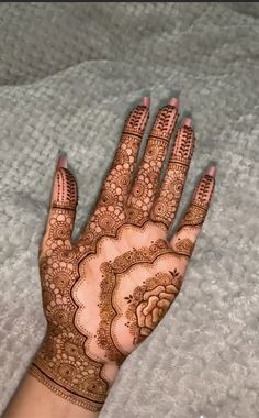 the hand is decorated with henna and flowers