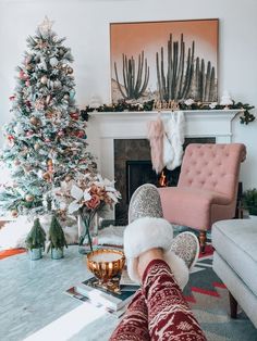 a living room filled with furniture and a christmas tree