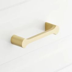 a brass handle on a white wall