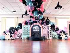 a room with balloons and decorations on the ceiling