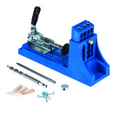 a machine that is sitting on top of a blue stand with tools in front of it