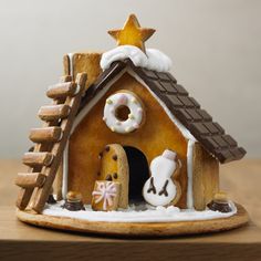 a gingerbread house is decorated with icing and decorations