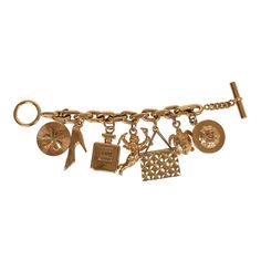 This 80's iconic vintage Chanel lucky charms bracelet features a 24K gold plated chain link with seven of Chanel's "iconic" lucky charms including a clover, shoe, perfume bottle, cherub, Chanel quilted handbag, turtle, and camellia flower. It also has a bar toggle and loop closure.Origin: FranceCondition: Vintage; Very Good - The charm bracelet shows sign of wear with scratching throughout. Some of the charms have chipped/peeled around the corners. There's some discoloration.Measurements: Length Classic Luxury Gold Charm Bracelet, Luxury Vintage Style Jewelry With Vintage Charm, Shoe Perfume, Lucky Charm Bracelet, Quilted Handbag, Camellia Flower, Charms Bracelet, Gold Charm Bracelet, Lucky Charms