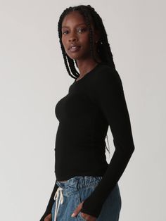 The Olivia long sleeve top is made from our stretchy rib knit and features our favorite undetected thumb holes. Pair with any sweatpants or style it up in your favorite denim. Fabric: 95% Rayon, 5% Spandex. Colorway: Onyx. Our model is 5'9" and wearing a size small. Machine Wash. Tumble dry low. Made in the USA. Stretch Long Sleeve Top With Thumbholes For Everyday, Black Long Sleeve Top With Thumbholes For Fall, Trendy Long Sleeve Top With Thumbholes For Fall, High Stretch Casual Long Sleeve Top For Layering, Casual Stretch Long Sleeve Top With Thumbholes, Casual Long Sleeve Top With Thumbholes For Fall, Black Stretch Long Sleeve Top For Loungewear, Versatile Long Sleeve Ribbed Top, Stretch Tops With Ribbed Cuffs For Everyday