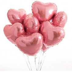 a bunch of pink heart shaped balloons