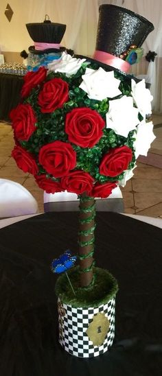 a bouquet of roses in a vase on top of a black table cloth covered table