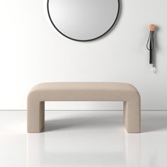 a modern bench in front of a round mirror